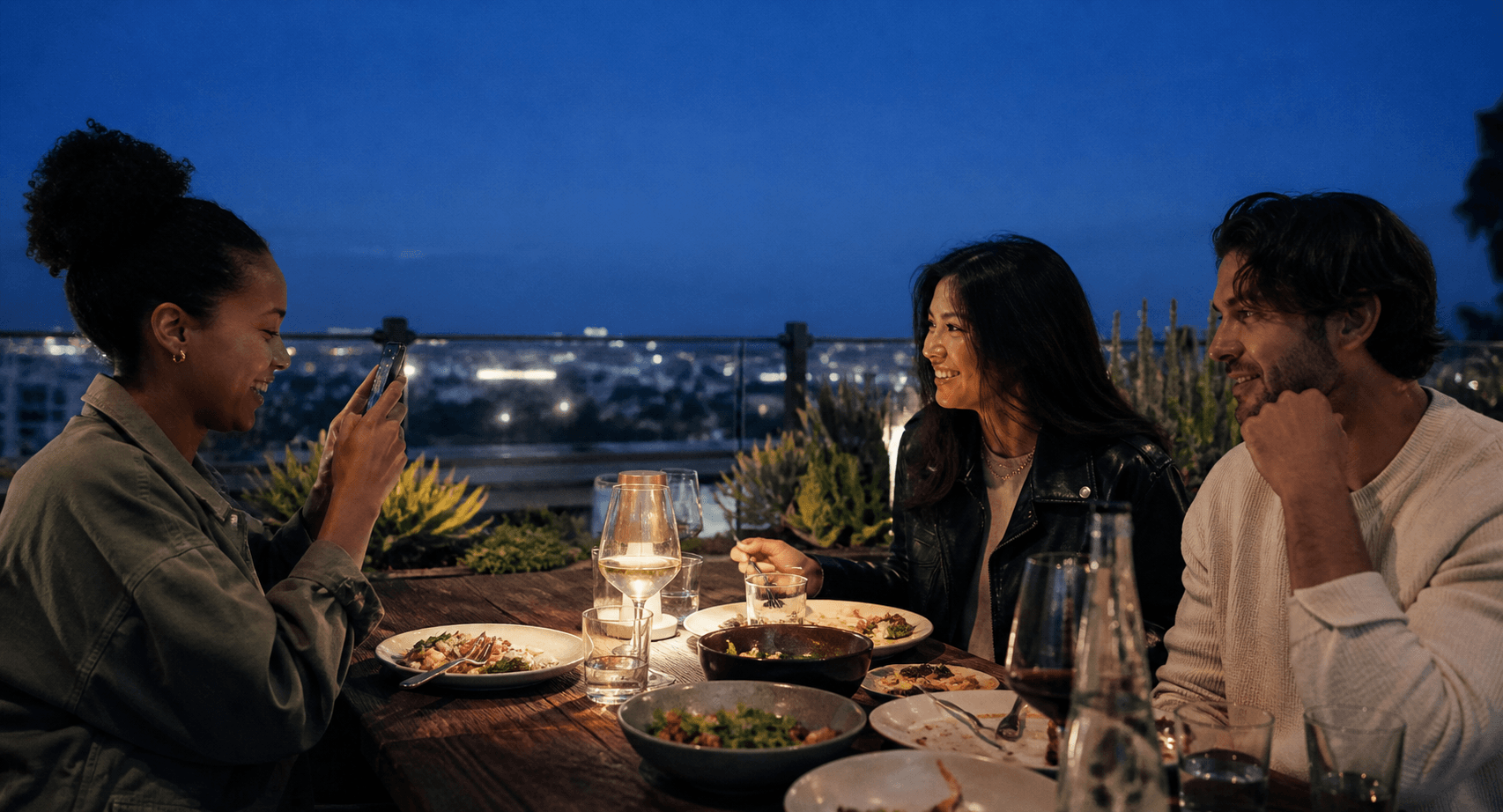 A creator photographing guests during a rooftop dining experience
