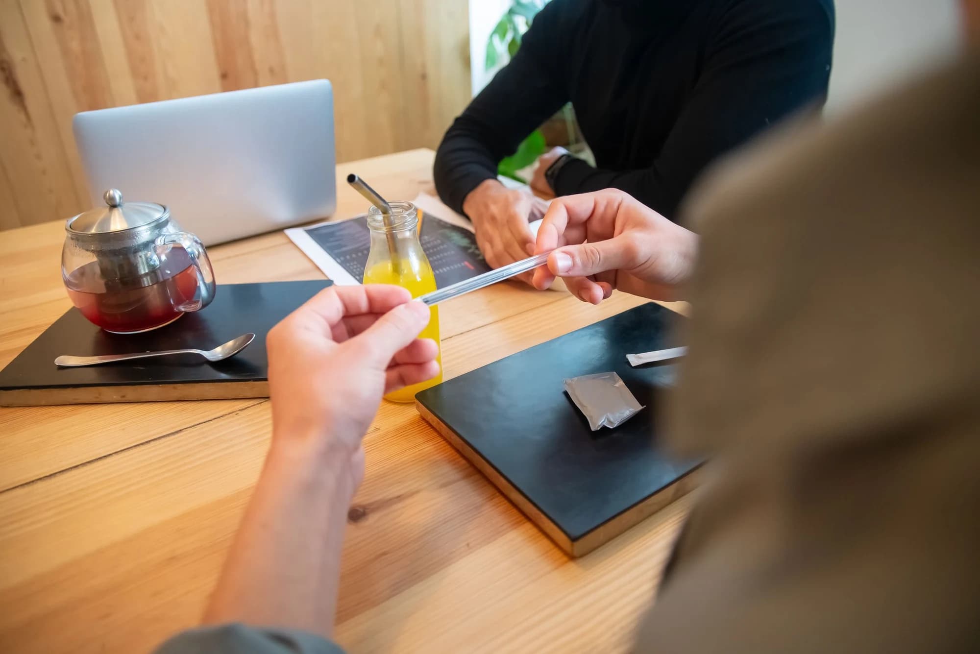 People discussing work together around a cafe table